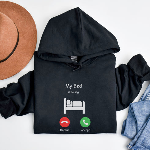 Introducing the ultimate hoodie for all those who love their bed more than anything else - the My Bed Is Calling hoodie! Featuring a hilarious stick figure lying in bed, this sweater is the perfect way to show off your love for all things cozy and comfortable.